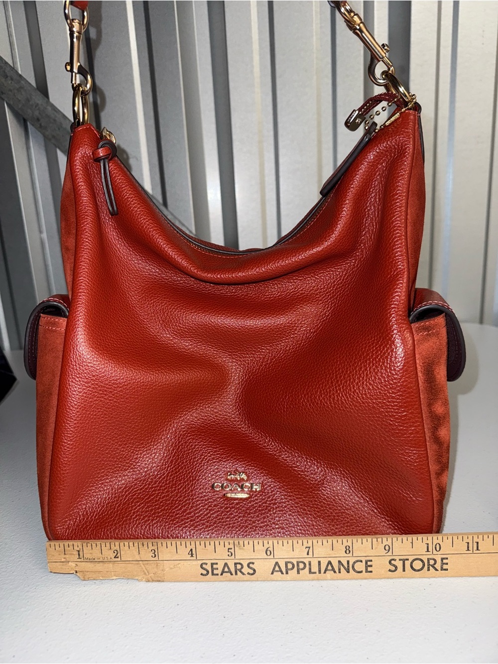 Coach Pennie Shoulder Bag features gold hardware and side suede pockets - Picture 15 of 15